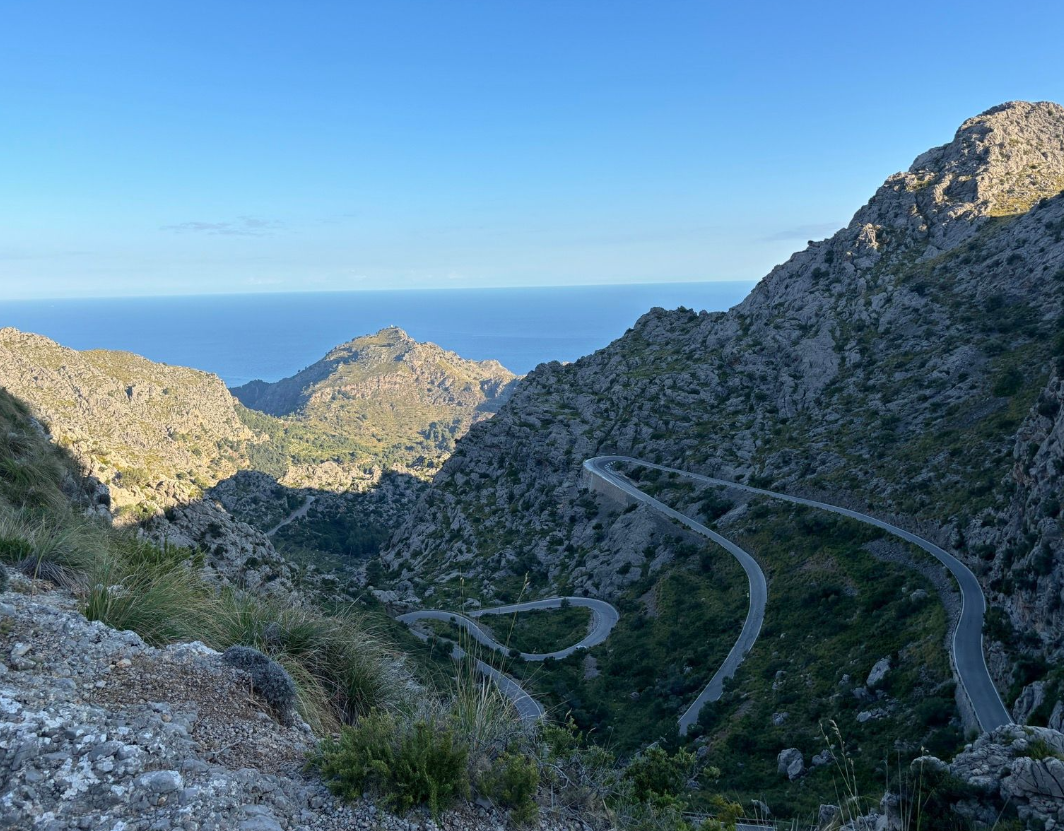 Cyclists riding a technical mountain crossing in the Serra de Tramuntana, Mallorca
